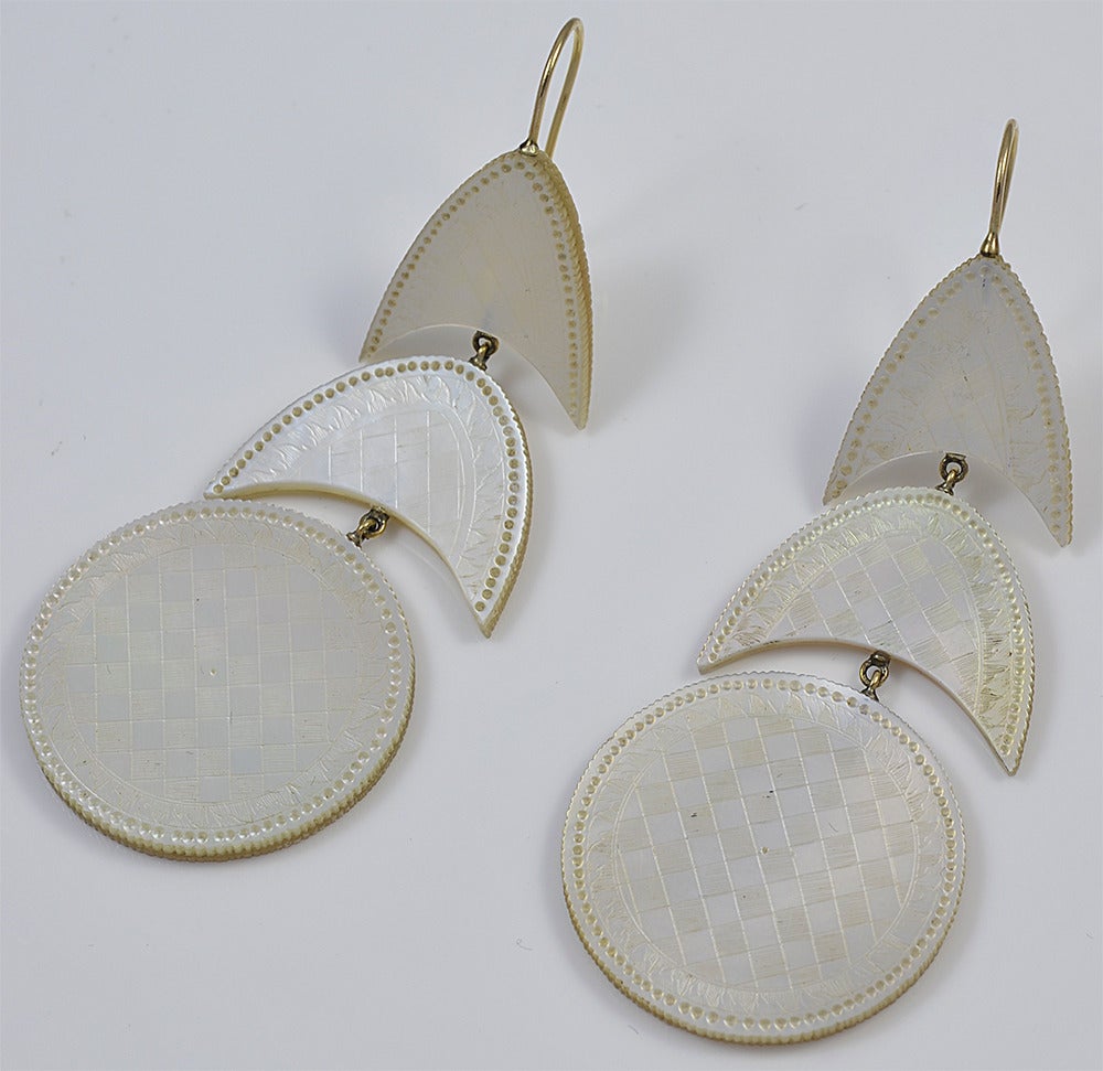 Dramatic, beautifully engraved Mother-of-Pearl drop earrings will stand out in every locale. In daytime or nighttime, in summer or winter they will catch the eye and stir the soul. They measure 3