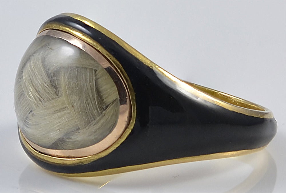 Elegant black enamel and woven hair memorial ring set in 18K gold. It is engraved 