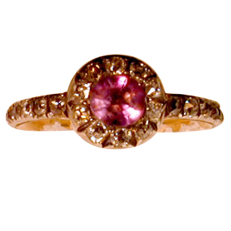 This antique amethyst and diamond ring set in 15K gold would certainly have been worn by an elegant lady. The diamonds are cushion cuts and encircle two thirds of the band. The Georgians had a penchant for paler hues for their evening attire because