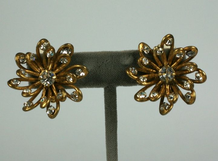 Lovely handmade flower earrings by Goossens for Chanel. Looped gilt wires free form the flowerheads which are studded and centered with pastes.  Clip back fittings.    1 3/8