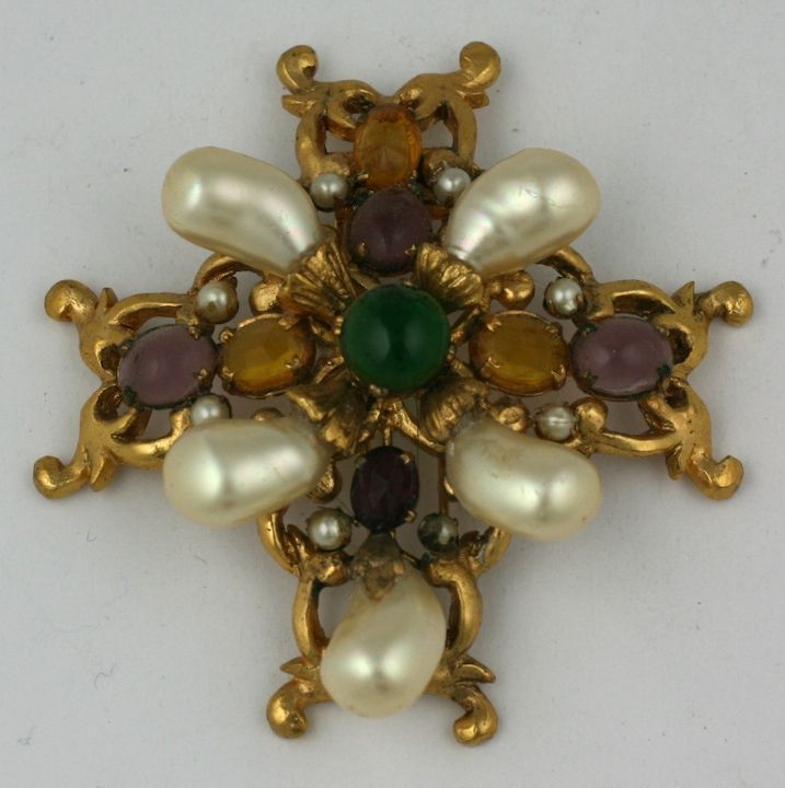 Another version of one of Chanel's favorite Renaissance crest brooches with tooth pearls, faux citrines and amythests. Created by studio Maison Goossens, this double prong clip brooch is centered with an emerald pate de verre cabochon and decorated