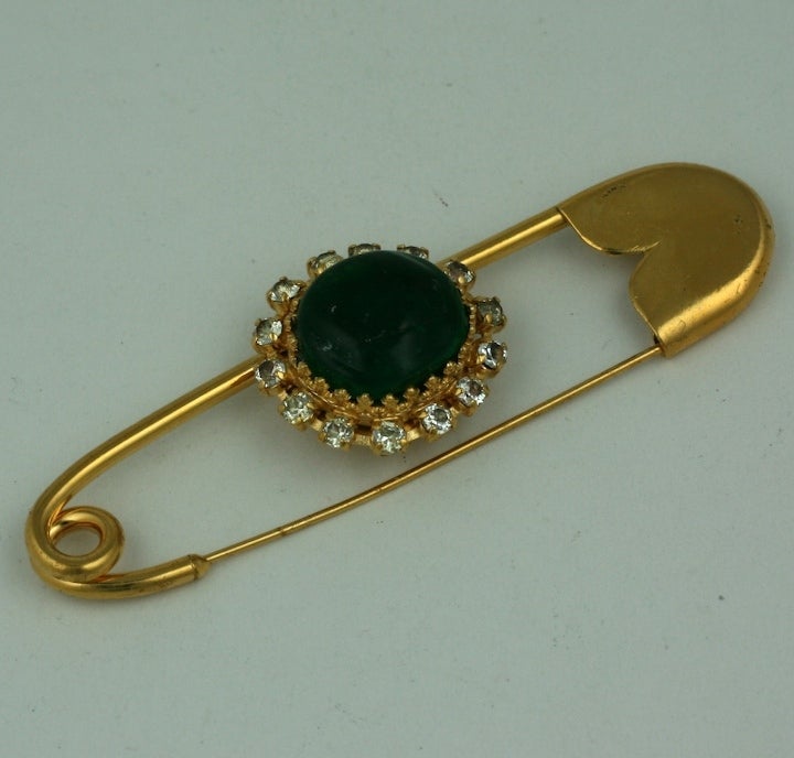 Coco Chanel synthesizes her love of rare tumbled precious stones, with the Kilt Pin (her visits to the Scottish Highlands) into one large signature brooch.
This large gilt bronze brooch is made by hand by Maison Goossens. Of  classic Kilt pin form