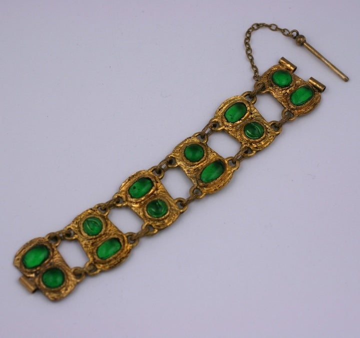 Chanel link bracelet in antique gilt bronze with pate de verre faux emerald cabochons in the Renaissance taste. Handmade in a process unique to Goossens in which the glass is applied from the back as opposed to the front.  The stones look