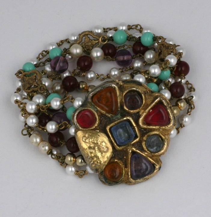 Unusual bead bracelet from Chanel with Byzantine inspired clasp of jelly molded poured glass stones handmade by Atelier Goossens. Multiple strands of poured glass beads in amythest and turquoise are mixed with Chanel's signature pearls with gilded