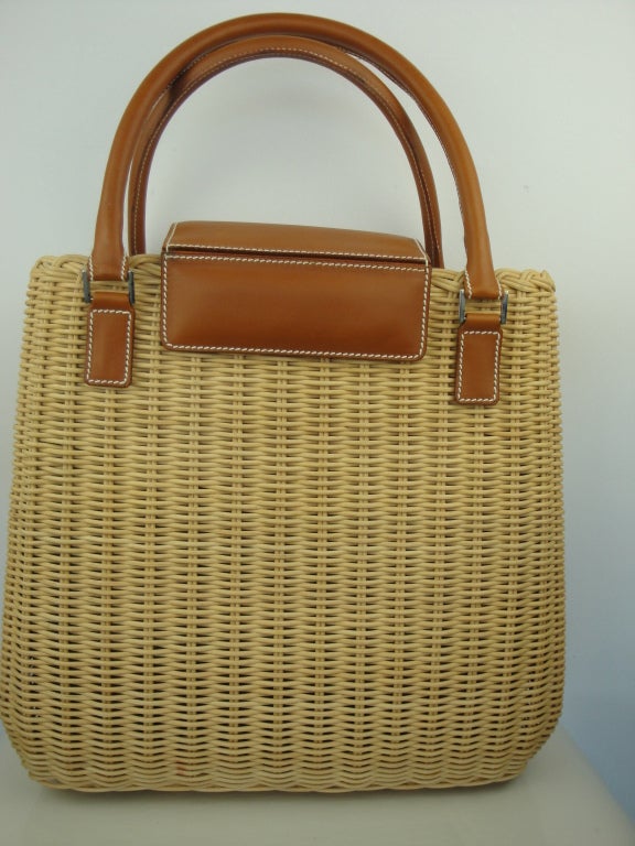 Lambertson Truex wicker and cognac leather long handbag,fully lined in linen,magnetic snap,one zippered pocket,cell phone pocket and key holder.