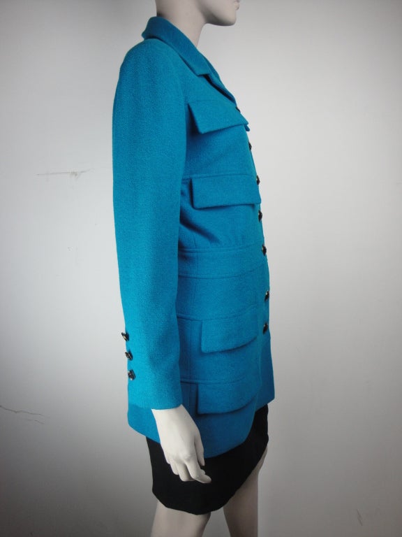 Karl Lagerfeld teal blue and black wool,angora skirt suit. The long,fitted jacket has six faux pockets,two useable pockets,seven black rose buttons,sleeve having six rose buttons,back vent and fully lined in teal silk. The teal and black skirt has