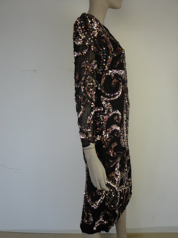 Oleg Cassini black silk chiffon paisley beaded and sequined long sleeve dress,back vent, back zip and fully lined.

Circa 1980