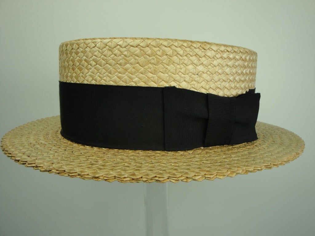 Stetsons boater staw hat with black grosgrain band from McDevitts men's shop.