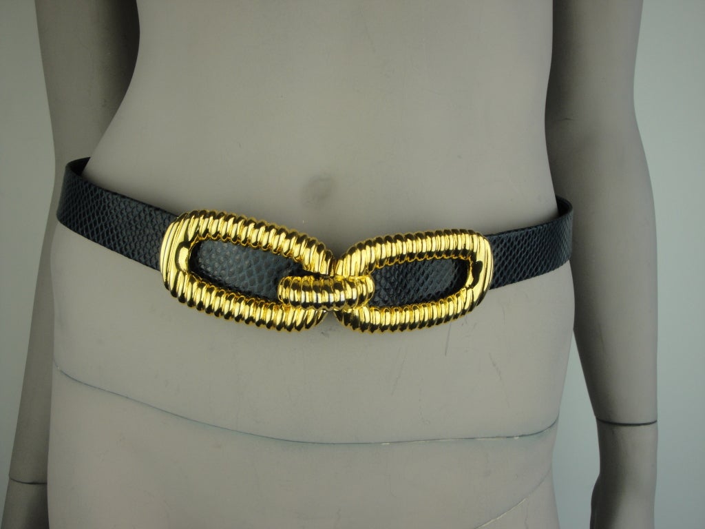 Alexis Kirk navy blue belt with gold buckle.