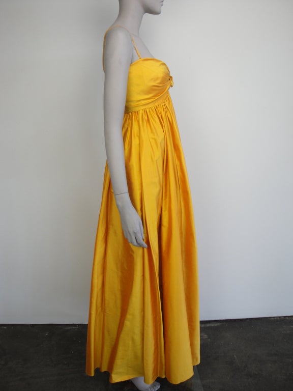 Donna Karan golden silk long dress with two front pockets and back zipper.