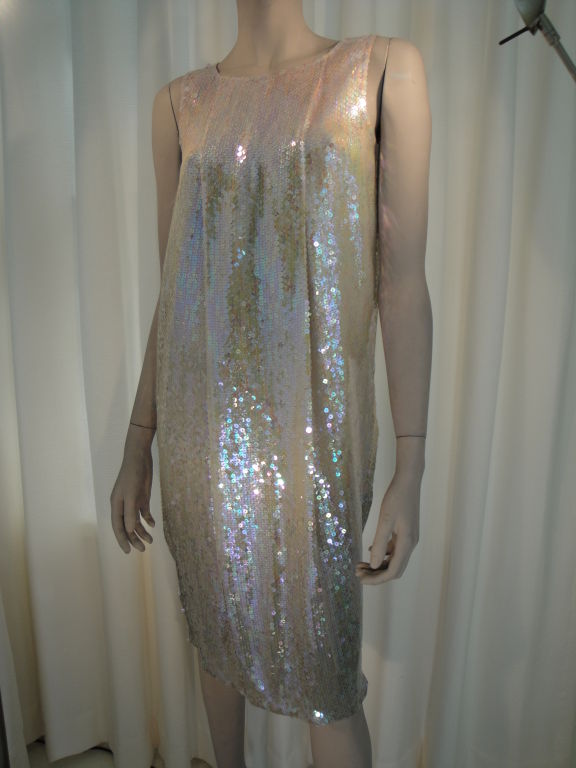 Silk chiffon sleeveless sheath with allover iridescent sequins lined in silk.