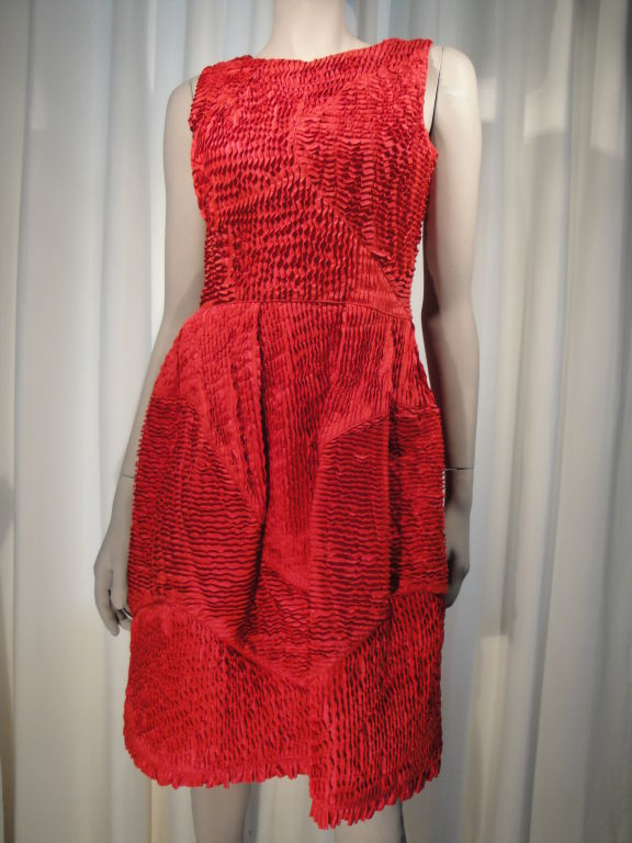 Red sleeveless silk cocktail dress, side zipper,and side self button closures,with two pockets.