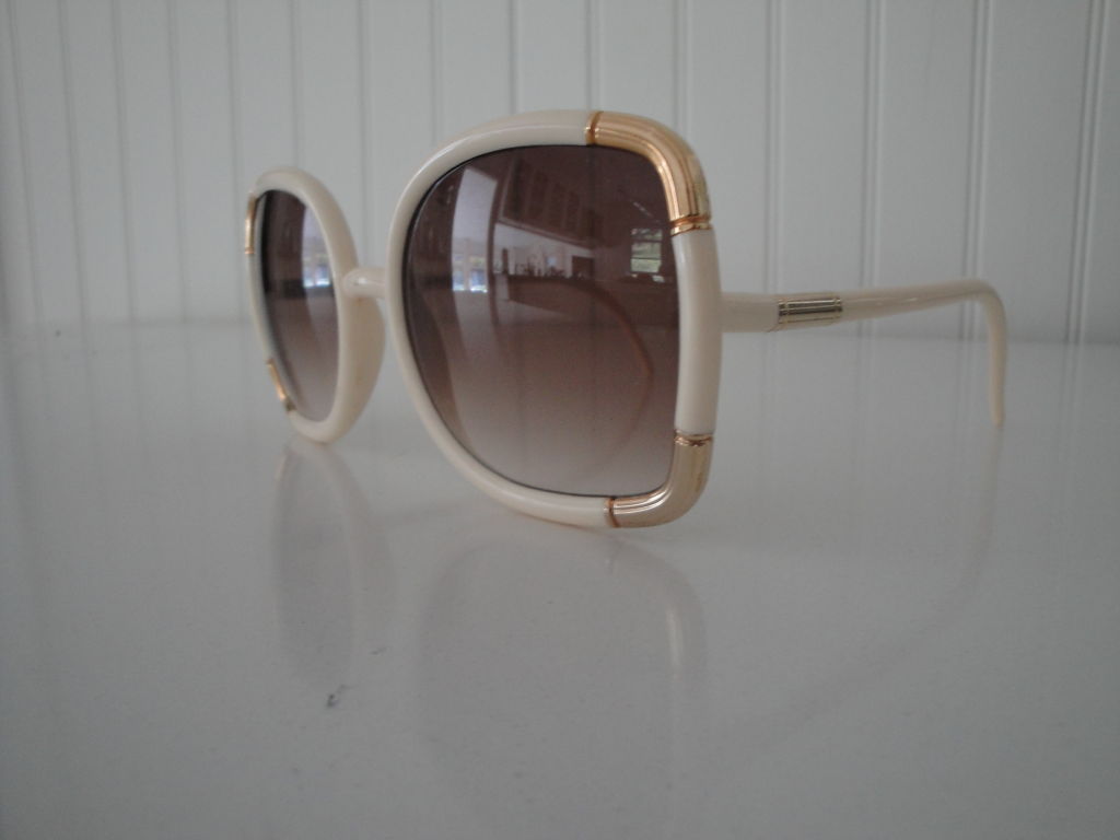 Cream and gold oversized sunglasses with gilt accents and original signature case.