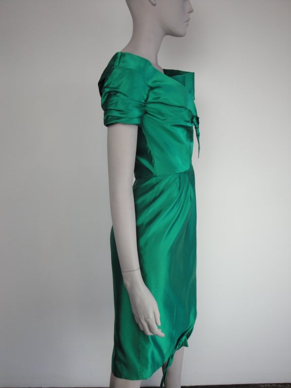 Ceil Chapman emerald green satin cocktail dress,inset boning to sides,short gathered sleeves,pleats at waist,back zipper and fully lined.