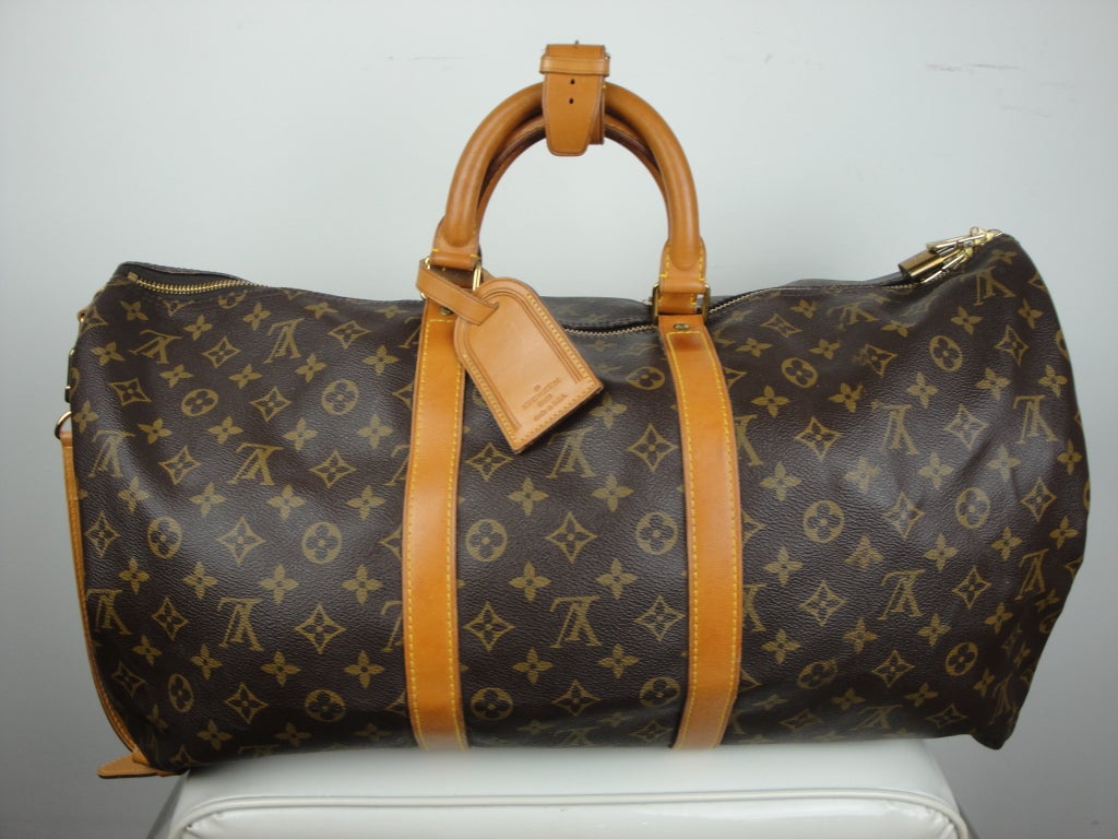 Louis Vuitton guaranteed authentic monagram canvas keepall 60 bandouliere travel bag.