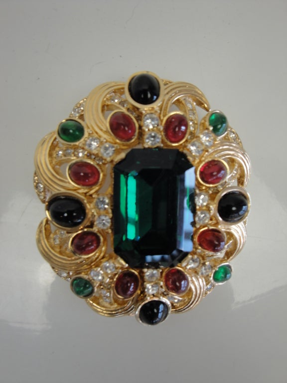Ciner gold tone brooch with jewel tone cabachons.