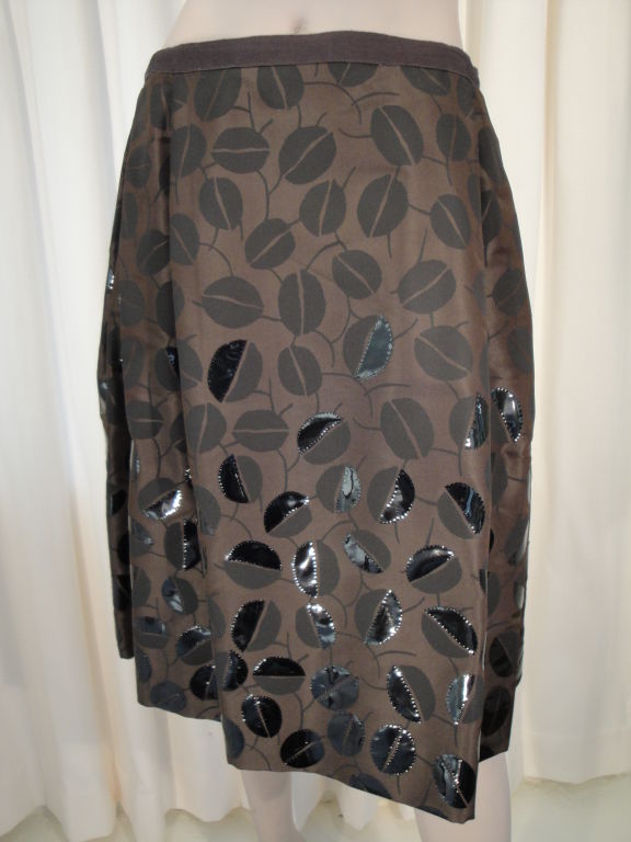 Oscar De la Renta silk skirt with cocoa bean print and exclusive black patent embroidery.