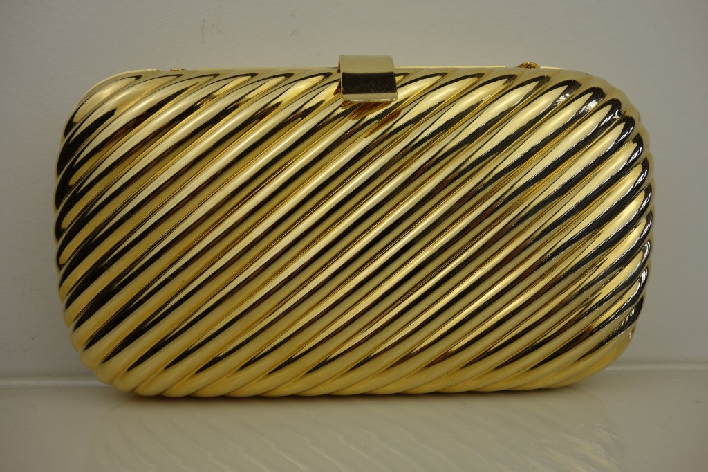 Gold-tone clutch,grey suede lining with long gold chain.