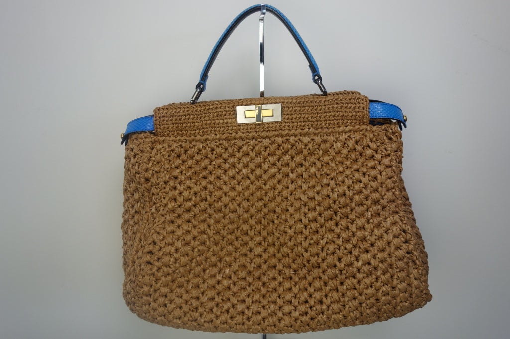 Fendi rafia peekaboo handbag,golden/silvertone hardware,blue water snake top handle,logo turnlock fastens peekaboo sides,inside blue water snake zip pocket and black suede lining.