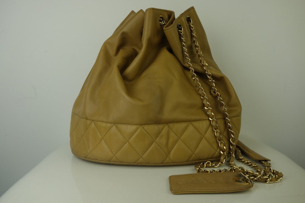 Chanel tan leather bucket handbag with attached coin purse.