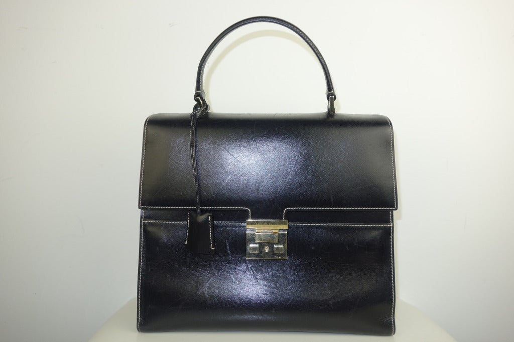 Gucci black leather handbag, red leather interior, two pockets with one zip and leather mirror.