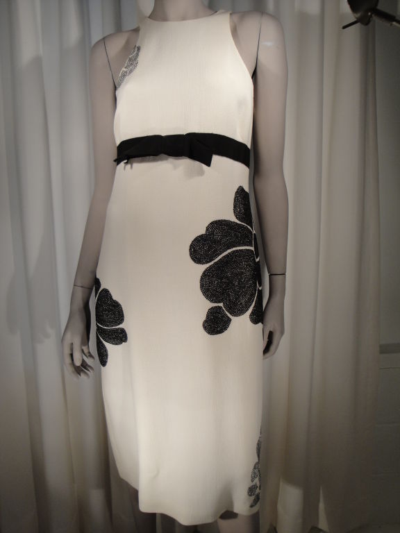 Ivory wool crepe sleeveless beaded dress with back zipper and fully lined.