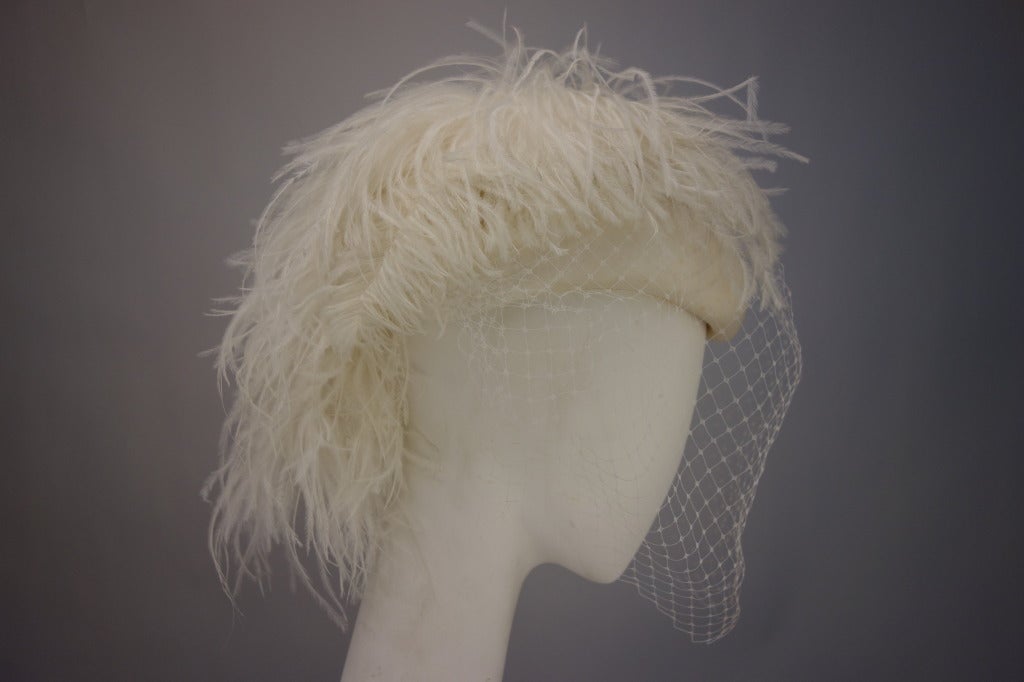 Philip Somerville for Harrods cream satin hat with mesh veil and ostrich feather.

Measurements:
Circumference 20.5