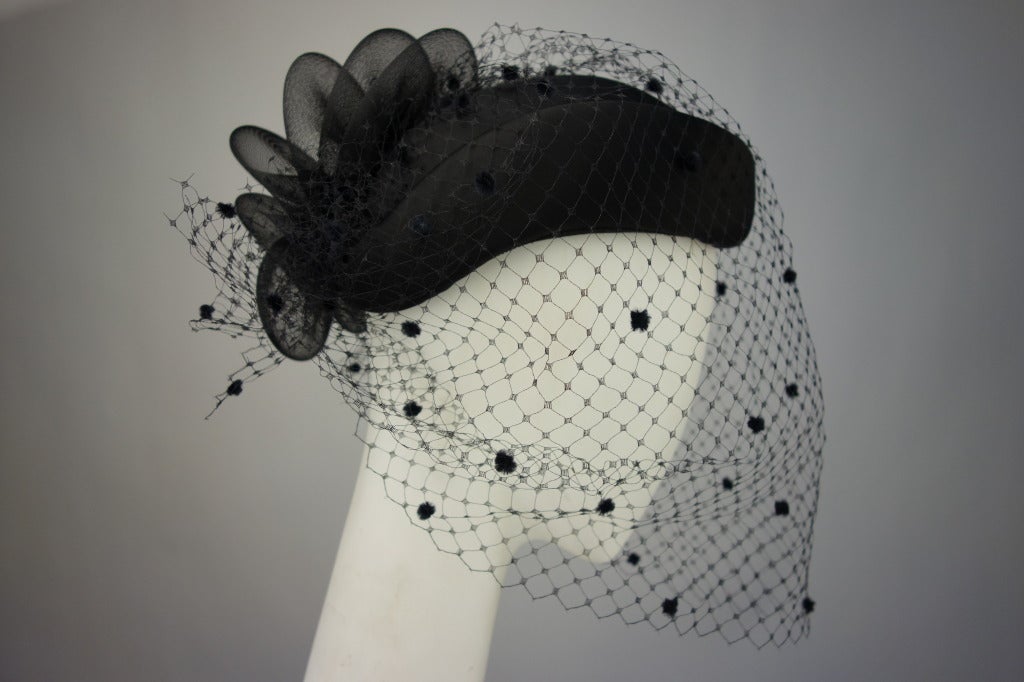 Philip Somerville for Harrods black satin hat with mesh veil.

Measurements: 20.5