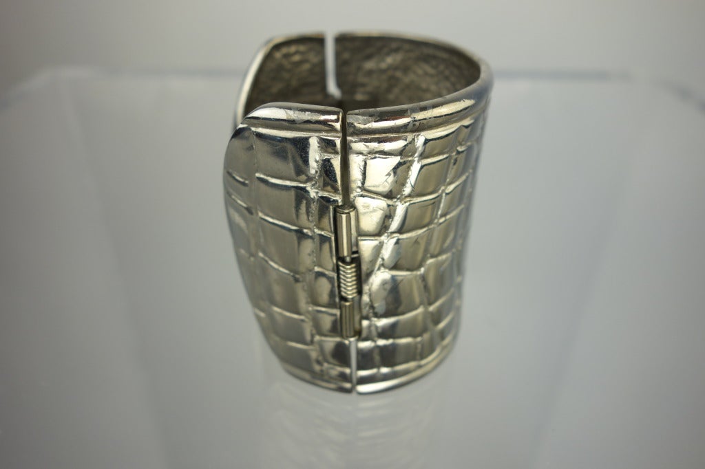 Alexis Kirk silver hinged cuff with reptile texture.

Circumference: 7.5