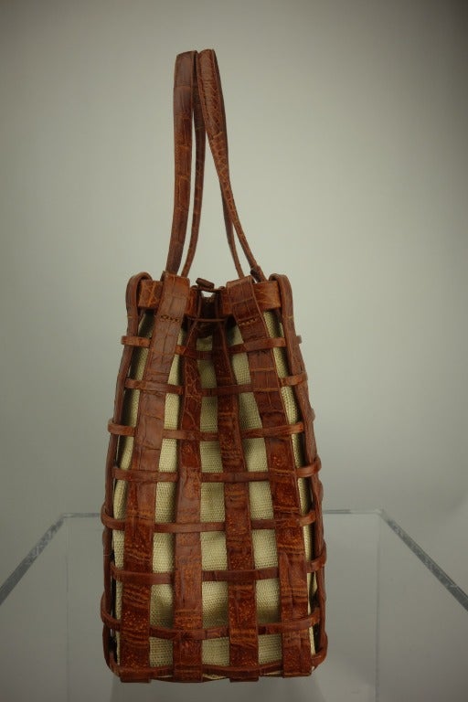 Nancy Gonzalez crocodile lattice with canvas underlay handbag, with loop bound closing, fully lined in suede, built-in interior zip change purse, and one interior zip side pocket.