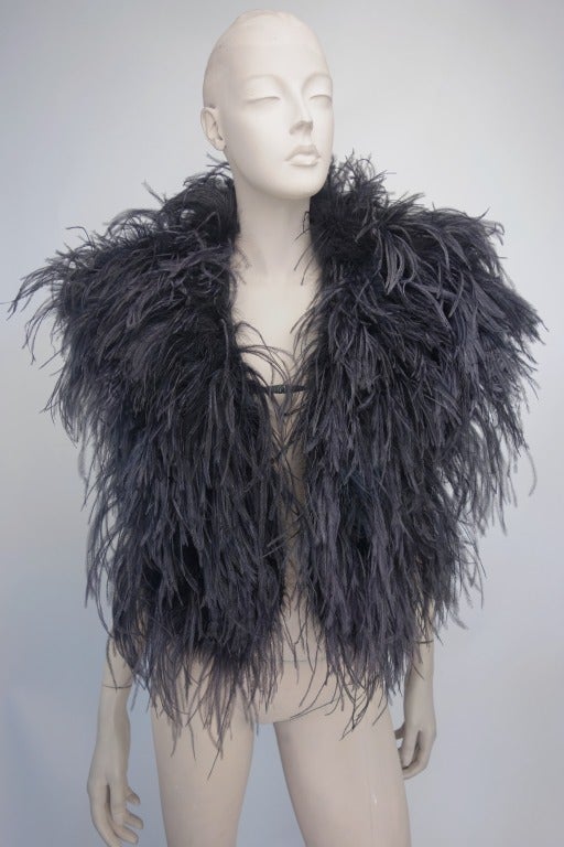 1940's black ostrich caplet fully lined with mini pocket underneath on one side, and clasp in center.