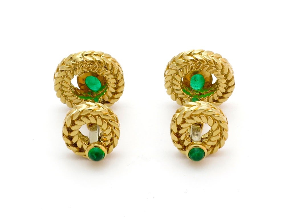 A pair of 18 karat gold cufflinks with emeralds by Van Cleef & Arpels. The cufflinks have 4 cabochon emeralds. Circa 1960. Signed, VCA C901DH2 18K 750 and French control marks, George Lenfant house mark.