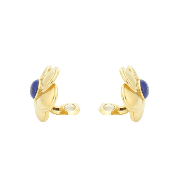 Featuring a pair of flowers with a lapis lazuli cabochon in the center by Van Cleef & Arpels. Signed VCA B 3492L3.