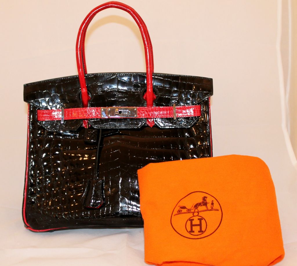 Hermes Black Alligator Birkin with red alligator strap, piping and belt. 2007 and in excellent pre-owned condition. This was a special order and is truly a one of a kind. Bag comes with box, duster, lock and key, rainpouch.