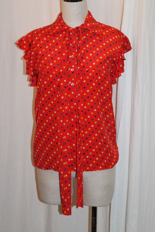 YSL red with multi color polka dot silk blouse with collar and neck sash. Ruffle cap sleeve. Size 36F. 15.5 inches shoulder to shoulder. Good vintage condition with minimal wear to fabric. 