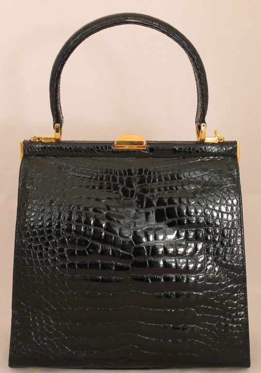 Elegant Lana Marks Alligator Black Handbag with changable handle/strap. GHW. Snap closure, pull tab. One interior zip pocket. Gold feet. Drop handle is 4.5 inches, and with strap it is 23 inches.