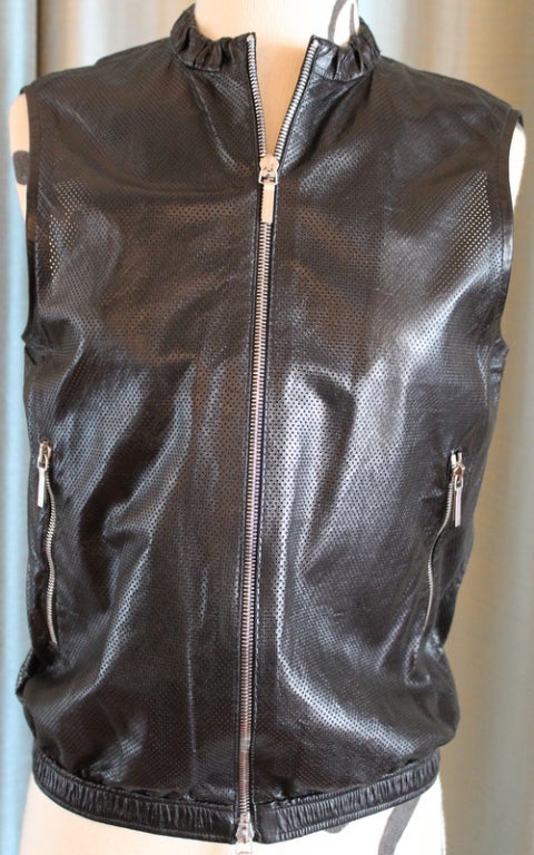 Jill Sander black perforated leather vest. Zip front. Sleeveless with elastic waist band. 2 zip front/side pockets. This item is in excellent condition.
Measurements are as follows:
Bust: 35