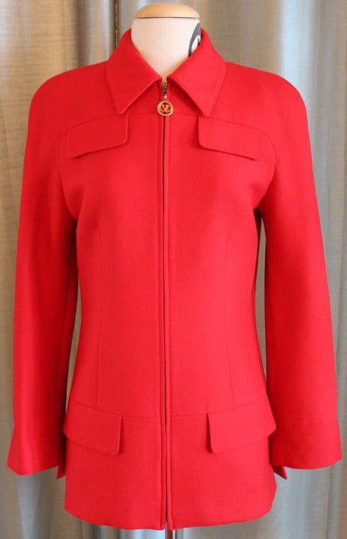 Valentino Miss V red long hunting jacket- Size 40 , US 6. Circa late 90’s.  4 faux flap front pockets, zip front with hanging gold V charm. Wool Blend. Jacket has mid size soft shoulder pad as the jacket does not have a shoulder seam. Shoulder to