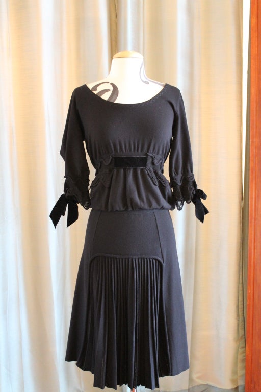 YSL black 2 piece dress, rayon blend, 3/4 sleeves. Top has knit trim and velvet bow, knit stitch waist with velvet ribbon. Skirt is knit with pleast, front and back. Shoulder to shoulder is 13.5 inches and sleeve length is 15 inches.