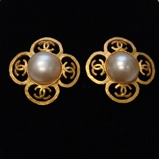 Chanel gold earrings with pearl center.  Clip ons, about 1.75 inches in diameter.