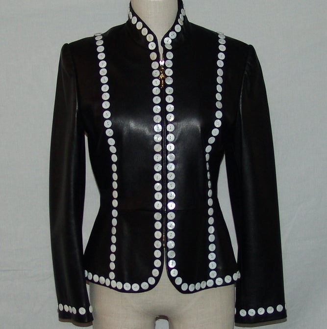 St. John black leather jacket, with white button detail, and a zipper front.  Length 23