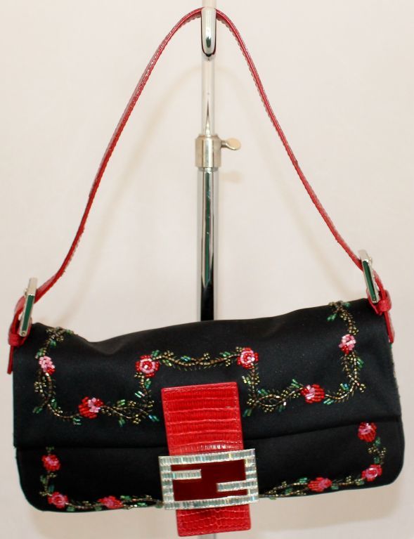 Fendi Black Silk baguette with floral motif in bugle beads. Red Snake strap and buckle with rhinestones. This bag is in excellent pre-owned condition. Comes with duster.<br />
Additional measurements: 8