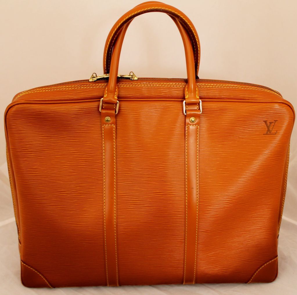 Louis Vuitton Honey Epi Leather Laptop/Briefcase. This item is at least 10 years old. The outside of the bag is in excellent condition. The inside leather in the zipper pocket area has some peeling to it. 
Bag Dimensions: 
Height: 12