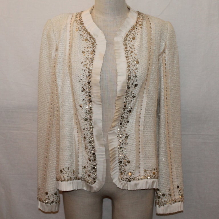 Oscar De la Renta Ivory jacket with beading around trim, size 12. This jacket is in excellent condition. 

Measurements:
Bust- 38