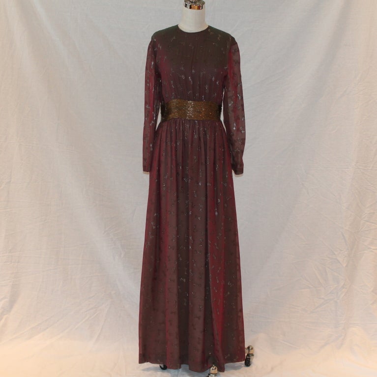 1970's Vintage Chanel Burgundy & Gold Iridescent Silk Chiffon Gown w/ gold metallic bows throughout fabric and beaded waistline. Colors and fabric are fabulous! Aprox Sz 10-12 -Circa 70's

Measurements:
Bust 38
Shoulder to Shoulder 17
Waist