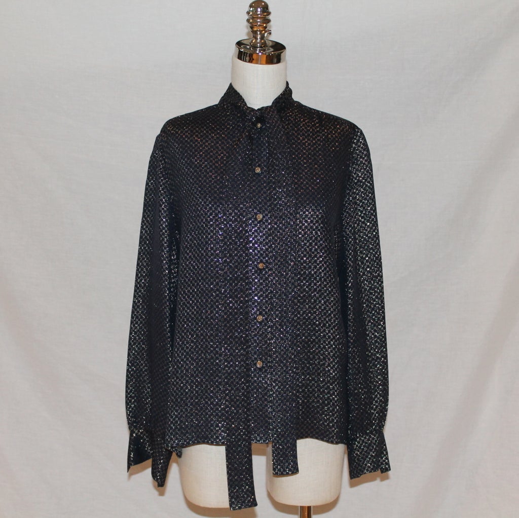  1970's Vintage Chanel Navy & Gold Lame Blouse with CC print- 40 - Circa 70's. The CC's are all over with Gold tinsel-like material. The buttons have the Chanel lion on them and the blouse also has a necktie option. Excellent vintage