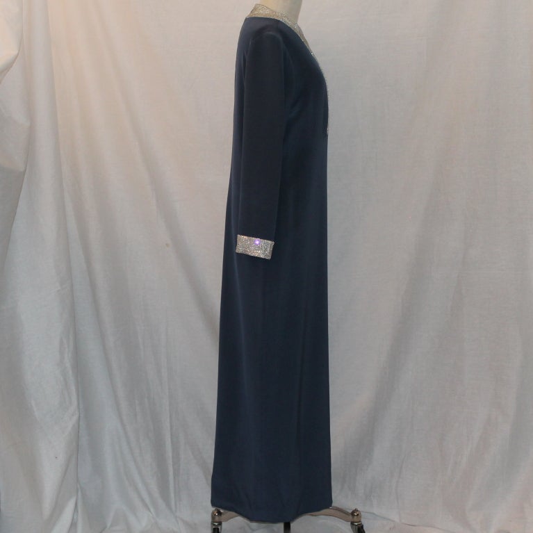 Donald Deal Blue Silk Gown with Rhinestone details throughout neckline and at cuffs on sleeves - Sz 12 Gown is in excellent pre-owned condition.
Sleeve length 23