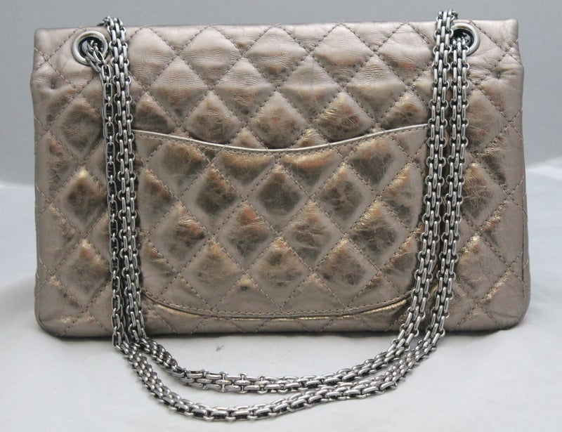 Chanel Bronze Metallic Lambskin 2.55 Double Flap - SHW - 226 size This beautiful reissue bag has the mademoiselle lock and chain in SHW. It is a spectacular metallic bronze lambskin. The bag is in very good condition. Circa 2007/2008.
