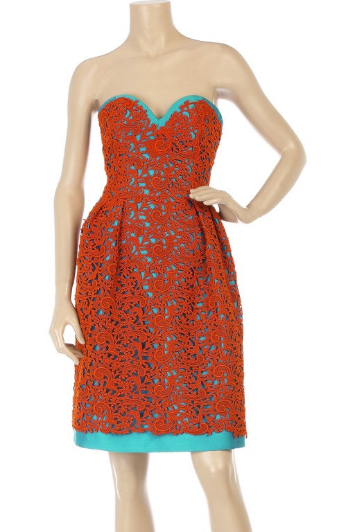 As seen on the runway. An exquisite offering by Oscar de la Renta. The simple shape allows its intricate fabric and the bold and beautiful clash of contrast colors to shine through. A stand-out investment piece. 

Caribbean blue-and-coral cotton