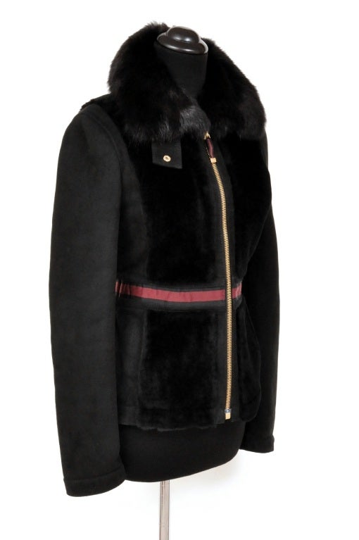 GUCCI SHEARLING JACKET

 Gucci's shearling jacket with genuine fur collar and iconic ribbon around the waist is the ultimate luxury for the fashion-forward.

Shearling inside and out
Color: Black
Gold tone zipper
 Ribbon around the waist and